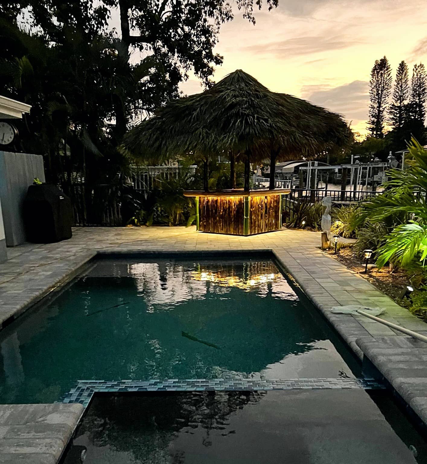 Small tiki bar next to a pool