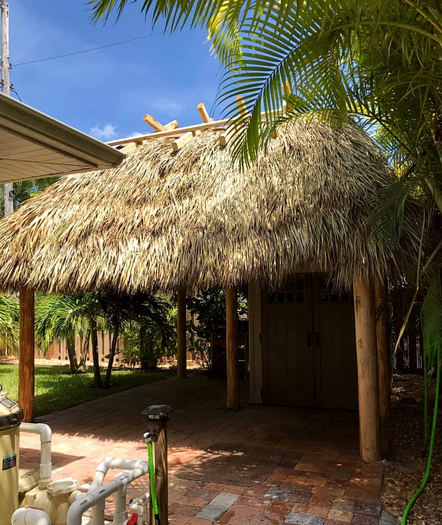 Tiki built in a backyard over pavers