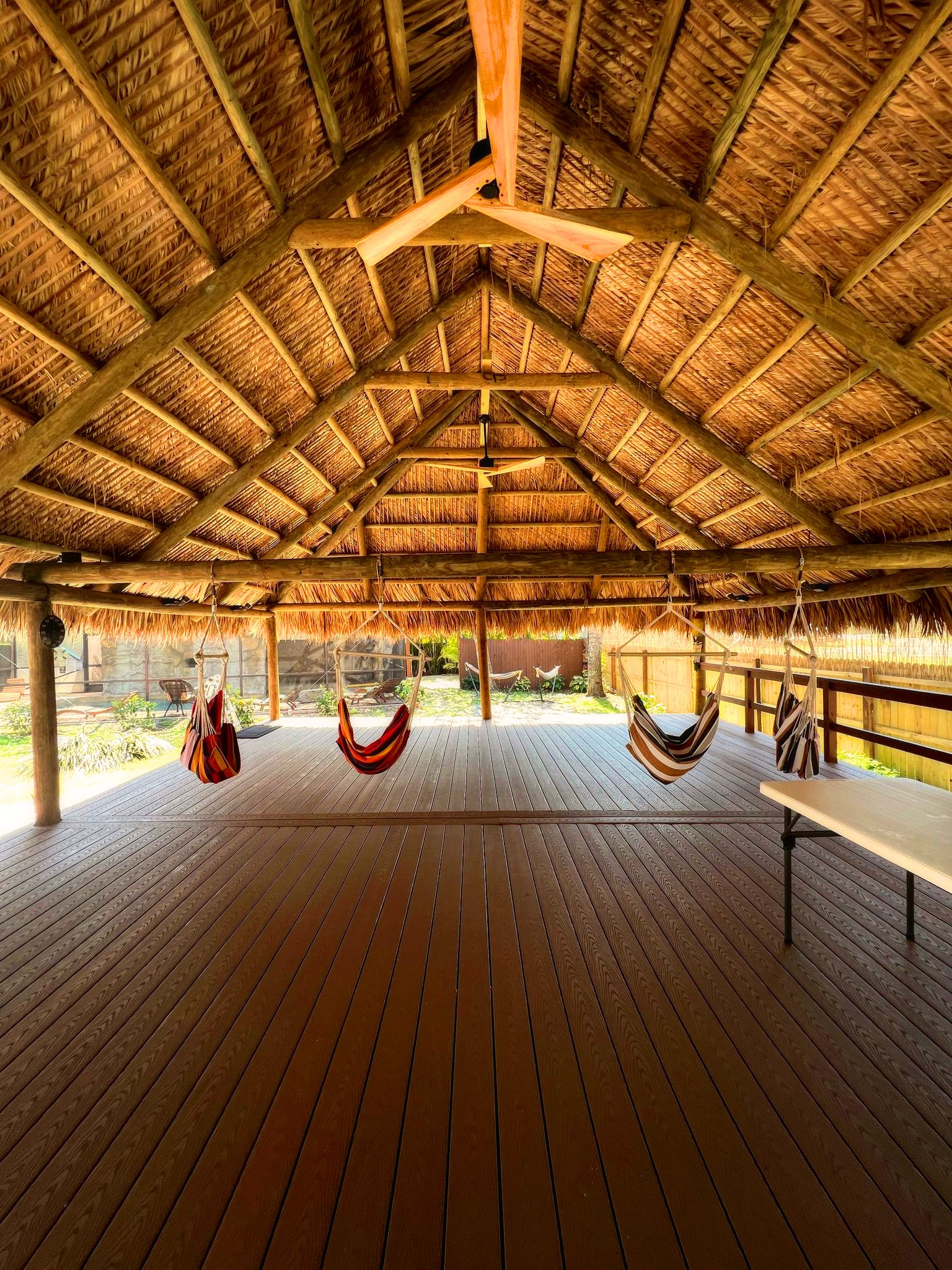 Large tiki with several hanging chairs suspended